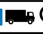 Direction to a lorry park via a U-turn at a roundabout ahead