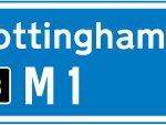 Direction to a motorway at the junction shown, indicating route number and destination reached along the motorway