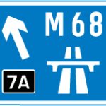 Direction to a motorway at the junction shown, indicating route number