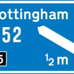 Motorway junction ahead, displaying the route number and destination reached by taking this route