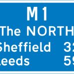 Route number of the motorway with destinations and distances to places along or reached from that route