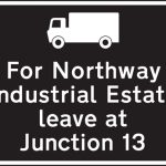 Exit from a motorway junction ahead that should be used for a destination along the route advised for goods vehicles