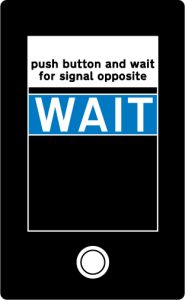 Instructions to pedestrians and cyclists above the push button control at a Toucan crossing