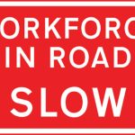 Vehicular traffic should proceed slowly owing to workforce in the road