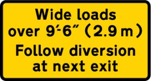 Instructions to drivers of wide loads to follow a diversion to avoid the road works ahead