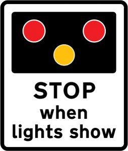 Warning of light signals at a level crossing without a gate or barrier ahead