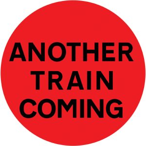 Another train or tramcar may be about to pass over the level crossing