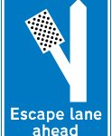 Escape lane to left for vehicles unable to stop on a steep hill